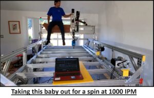 man rides the gantry of a 5 Prime CNC router